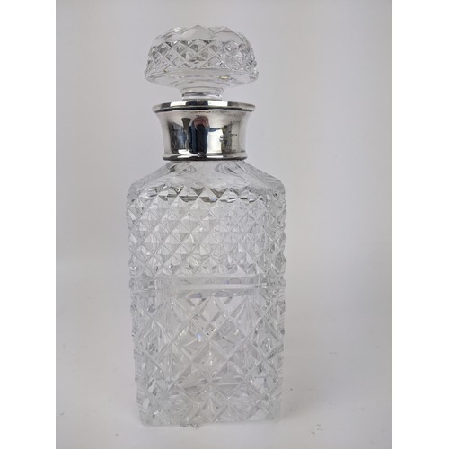 100 - A Mills & Hersey glass spirits decanter with a silver collar, London 1973, with line cut decoration,... 