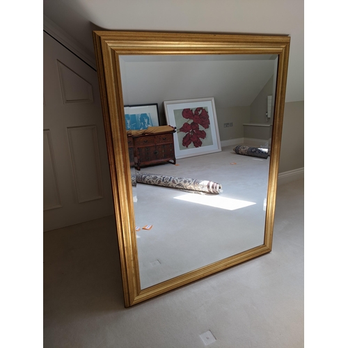 290 - A large bevelled glass mirror with a moulded gilt frame, 135cm high, 96cm wide together with a large... 