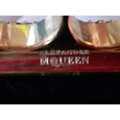 6 - Alexander McQueen-A fabric clutch bag with gold tone four ring knuckle duster clasp with skull and j... 