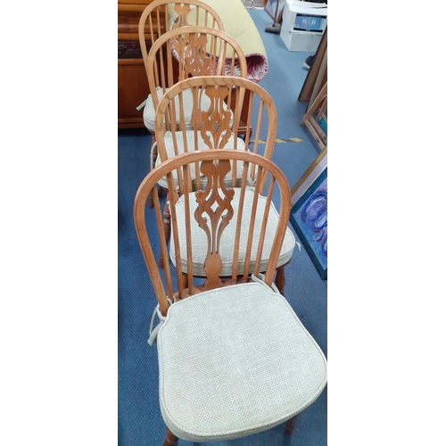 106 - Four 20th century spindle backed elm and ash dining chairs with pierced backs with crinoline stretch... 