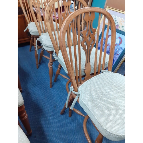 106 - Four 20th century spindle backed elm and ash dining chairs with pierced backs with crinoline stretch... 