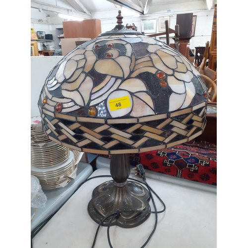 48 - A Tiffany style table lamp, the shade in tones of brown with inset amber coloured beads, Location:RA... 