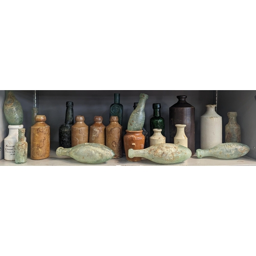 352 - A group of mixed 18th/19th century glass and stoneware bottles and flasks A/F, to include advertisin... 