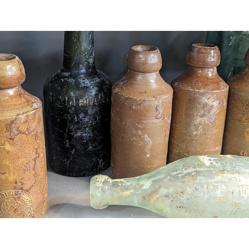 352 - A group of mixed 18th/19th century glass and stoneware bottles and flasks A/F, to include advertisin... 