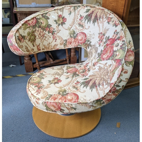 123 - A vintage Peel swivel chair having floral upholstery and on a light wood base
Location:A2F