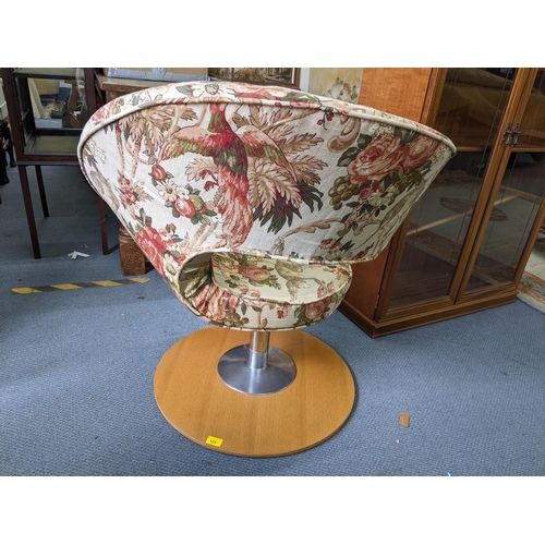 123 - A vintage Peel swivel chair having floral upholstery and on a light wood base
Location:A2F