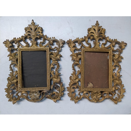 13 - A pair of Victorian gilt metal picture frames decorated with floral scrolls and having easel backs
L... 