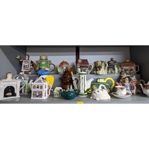 149 - A quantity of novelty teapots to include a Disney Donald Duck teapot, a vintage car teapot, Tony Woo... 