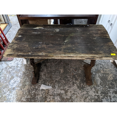 160 - THIS LOT HAS BEEN WITHDRAWN

A wooden plank top pub table on cast iron trestle and base 71cm x 105cm... 