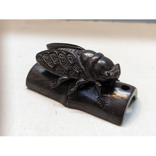 182 - A Japanese treen carved netsuke of a Cicada perched on bamboo
Location:CAB1