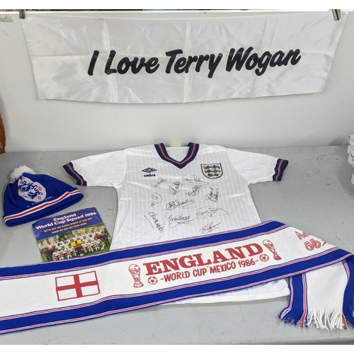 2 - A collection of England Football 1986 memorabilia to include a signed shirt with eleven signatures, ... 