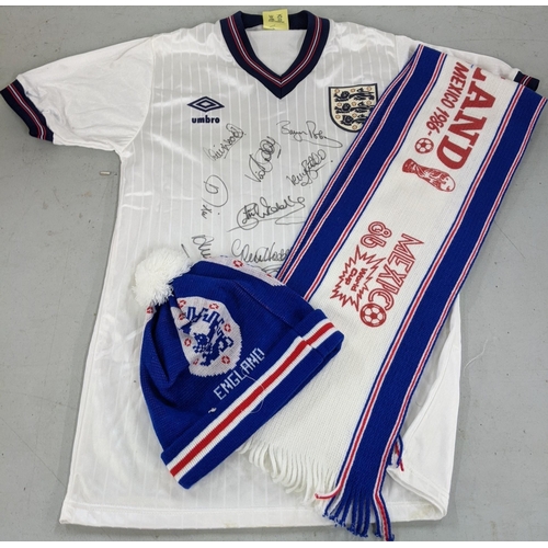 2 - A collection of England Football 1986 memorabilia to include a signed shirt with eleven signatures, ... 