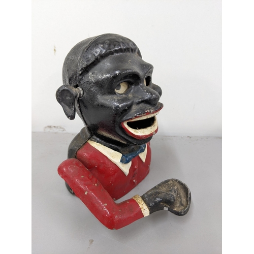 27 - An early 20th century cast metal money box fashioned as an African man Location:4.2

These items are... 