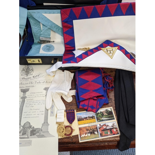 309 - A Masonic case containing two aprons, medals, black tie and other items Location:G