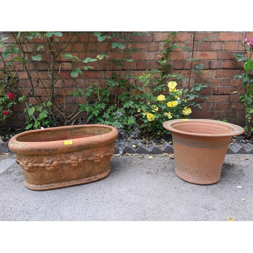 312 - Two terracotta garden planters, one from the Whichford Pottery Warwickshire, oval with a raised band... 