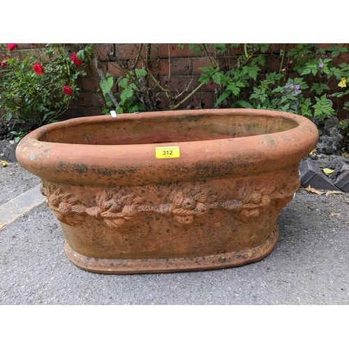 312 - Two terracotta garden planters, one from the Whichford Pottery Warwickshire, oval with a raised band... 