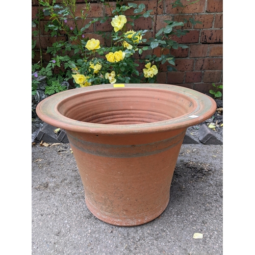 312 - Two terracotta garden planters, one from the Whichford Pottery Warwickshire, oval with a raised band... 