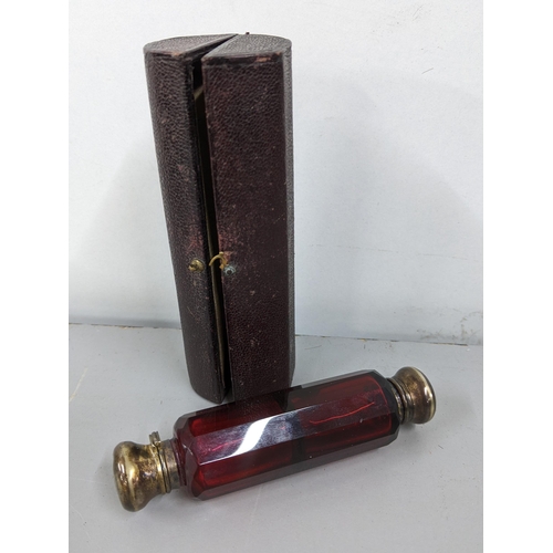 327 - A Victorian ruby glass double ended scent bottle with silver plated caps, in a fitted case
Location:... 