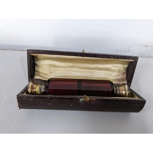 327 - A Victorian ruby glass double ended scent bottle with silver plated caps, in a fitted case
Location:... 