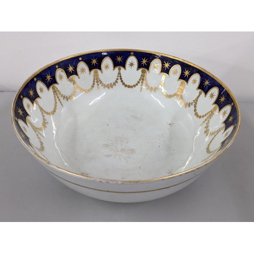 343 - A large 19th century porcelain punch bowl having a blue border with gilt swags below, 12cm h x 31cm ... 