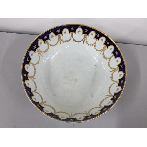 343 - A large 19th century porcelain punch bowl having a blue border with gilt swags below, 12cm h x 31cm ... 