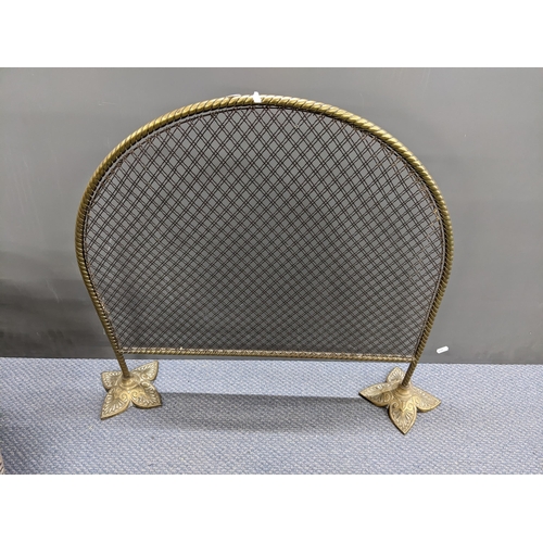 345 - A late 19th/early 20th century brass arch top fire screen, 64.5cm h x 77cm w together with a twin ha... 