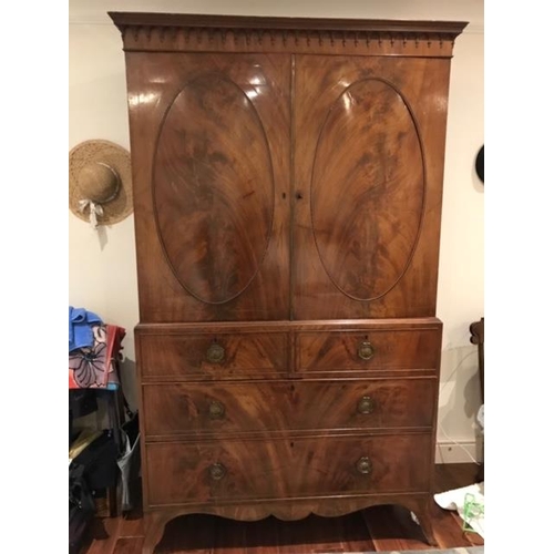 354 - An early 19th century mahogany wardrobe converted from a secretaire having two cupboard doors above ... 