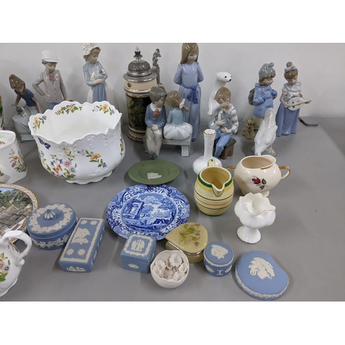 369 - A mixed lot to include Nao figures, Wedgwood Jasperware, Parian jugs, Portmeirion Botanic Garden and... 