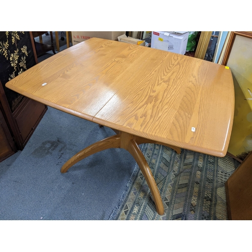 370 - An Ercol Windsor elm extending dining table, model 1992, 73cm h x 104cm w, together with a set of si... 