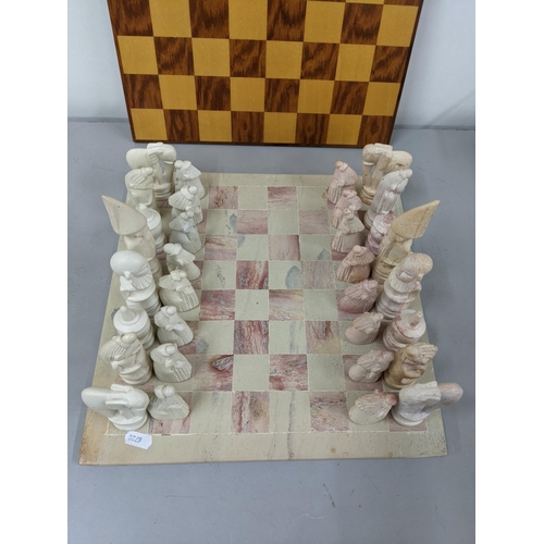 41 - A soapstone chess board having engraved chess pieces, along with a wooden chessboard Location:1.2