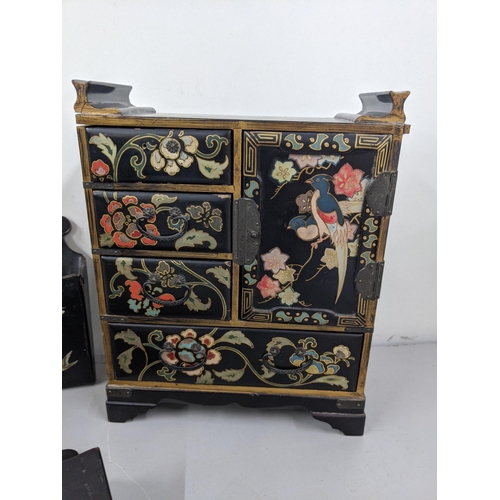 43 - Black lacquered papiermache comprising a pair of wall pockets, and a table top cabinet Location:10.3