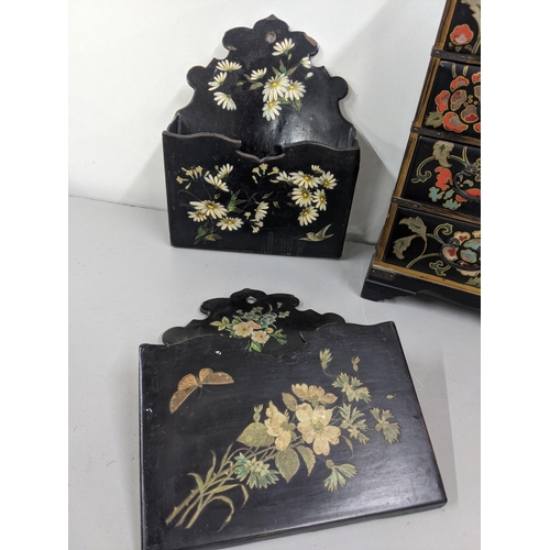 43 - Black lacquered papiermache comprising a pair of wall pockets, and a table top cabinet Location:10.3