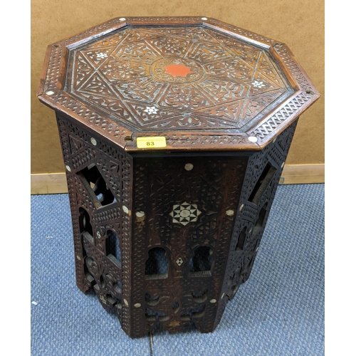 83 - A late 19th/early 20th century Indian octagonal carved occasional table having mother of pearl inlay... 