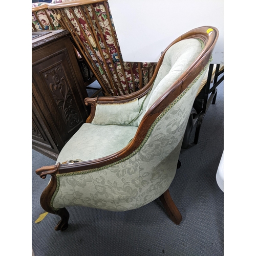 92 - A Victorian rosewood button, spoonback armchair having scrolled arms and two front cabriole legs, Lo... 