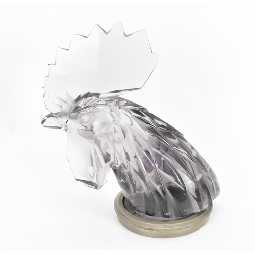 14 - A Lalique 'Tete de Coq' Car Mascot, in clear lilac glass modelled as a cockerel head, with metal mou... 