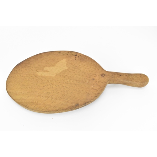 6 - Robert Thompson of Kilburn (1876-1955) Mouseman- an oval oak cheese board, with carved signature mou... 