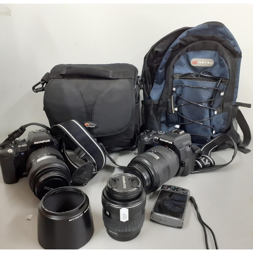 282 - A quantity of cameras to include two Olympia E500 digital cameras with lens, carols, accessories and... 