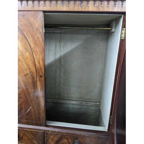 354 - An early 19th century mahogany wardrobe converted from a secretaire having two cupboard doors above ... 