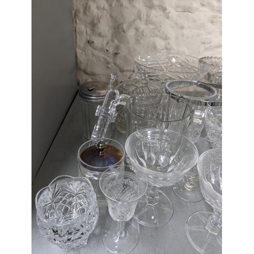 362 - A mixed lot of glassware to include a green glass apothecary bottle, decorative glass bowls, a sugar... 