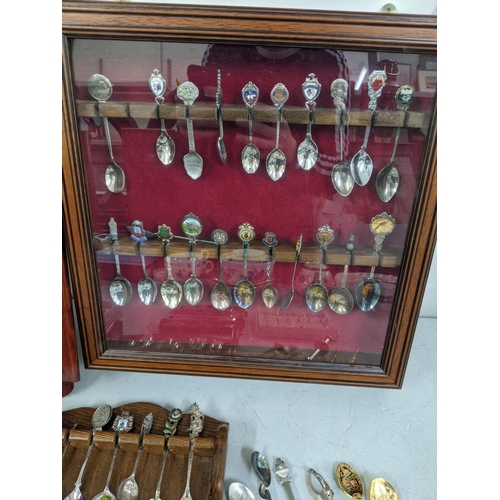 365 - A 22 spoon display wall cabinet, together with two wall display spoon racks, with a collection of te... 