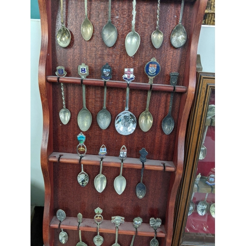 365 - A 22 spoon display wall cabinet, together with two wall display spoon racks, with a collection of te... 