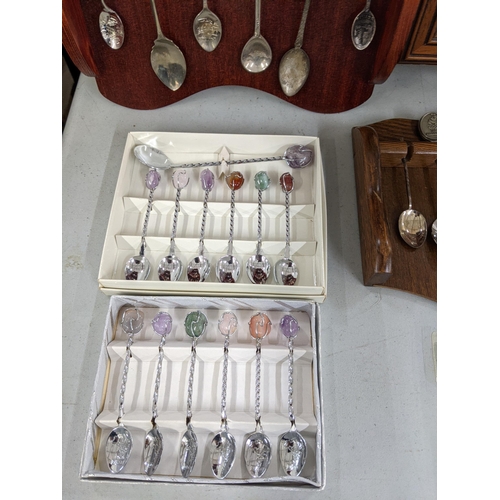 365 - A 22 spoon display wall cabinet, together with two wall display spoon racks, with a collection of te... 