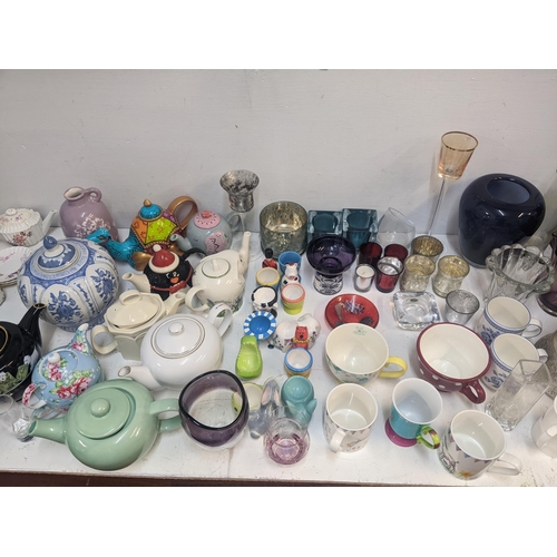 94 - Modern glass and ceramics to include a collection of decorative teapots, tea light holders, egg cups... 