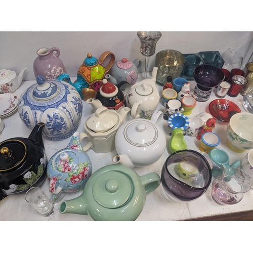 94 - Modern glass and ceramics to include a collection of decorative teapots, tea light holders, egg cups... 