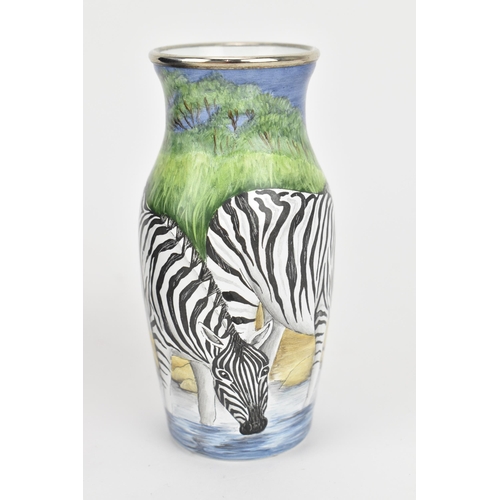 85 - A Moorcroft enamels hinged box, painted by Carol Yarnold, 2000, depicting a savanna scene with zebra... 