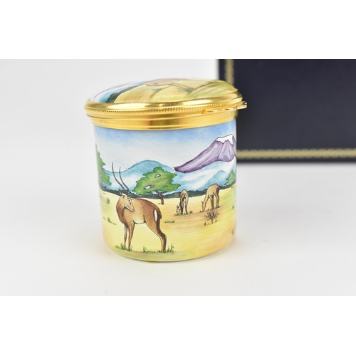 85 - A Moorcroft enamels hinged box, painted by Carol Yarnold, 2000, depicting a savanna scene with zebra... 