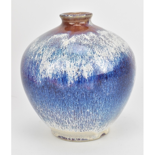 124 - A Cobridge stoneware high fired soliflore vase, designed with mottled and speckled blue/white/purple... 