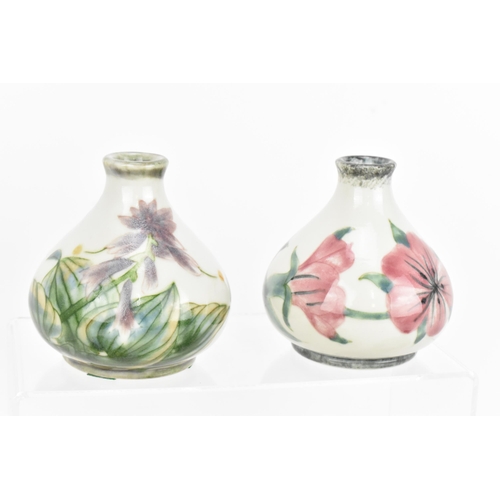 127 - A collection of five Cobridge ceramic bud vases, with various floral and fruit patterns, each with i... 