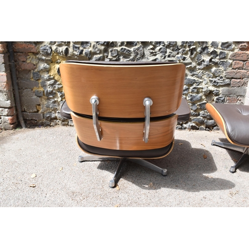 162 - A vintage brown leather armchair and ottoman, after the design by Charles and Ray Eames for Herman M... 