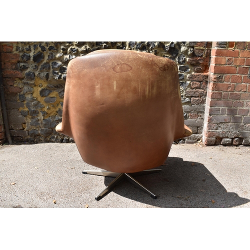 164 - A 1960s brown leather swivel chair and ottoman, probably by H.M Klein for Bramin Møbler, 88 cm high ... 